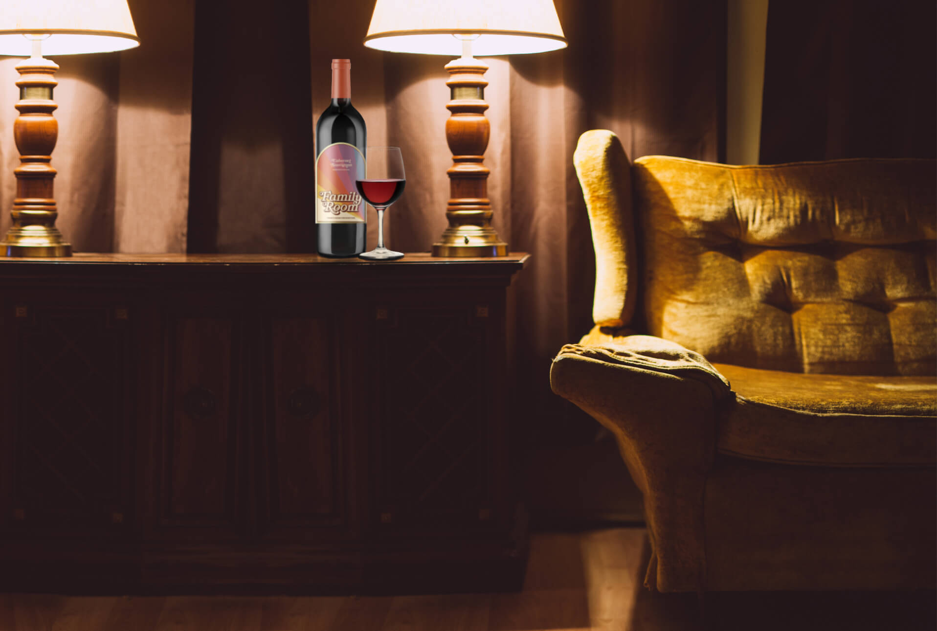 Family Room wine bottle next to a wine glass on a cabinet with lamps and a vintage gold sofa